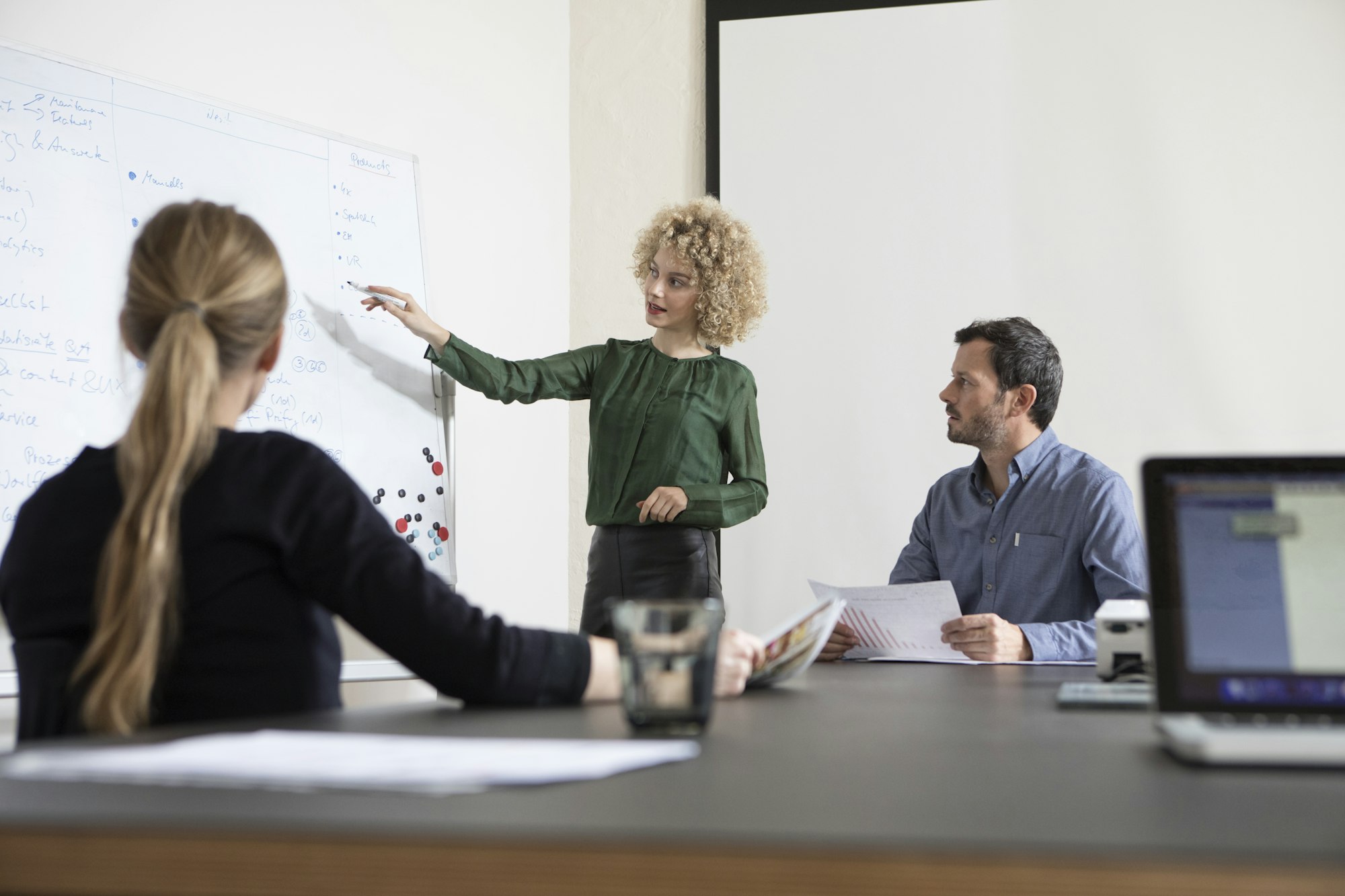 Woman in boardroom leading a presentation